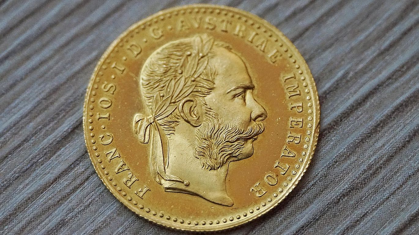 A Precious Metal Is - Close-up of gold bars and silver coins, symbolizing wealth and value.