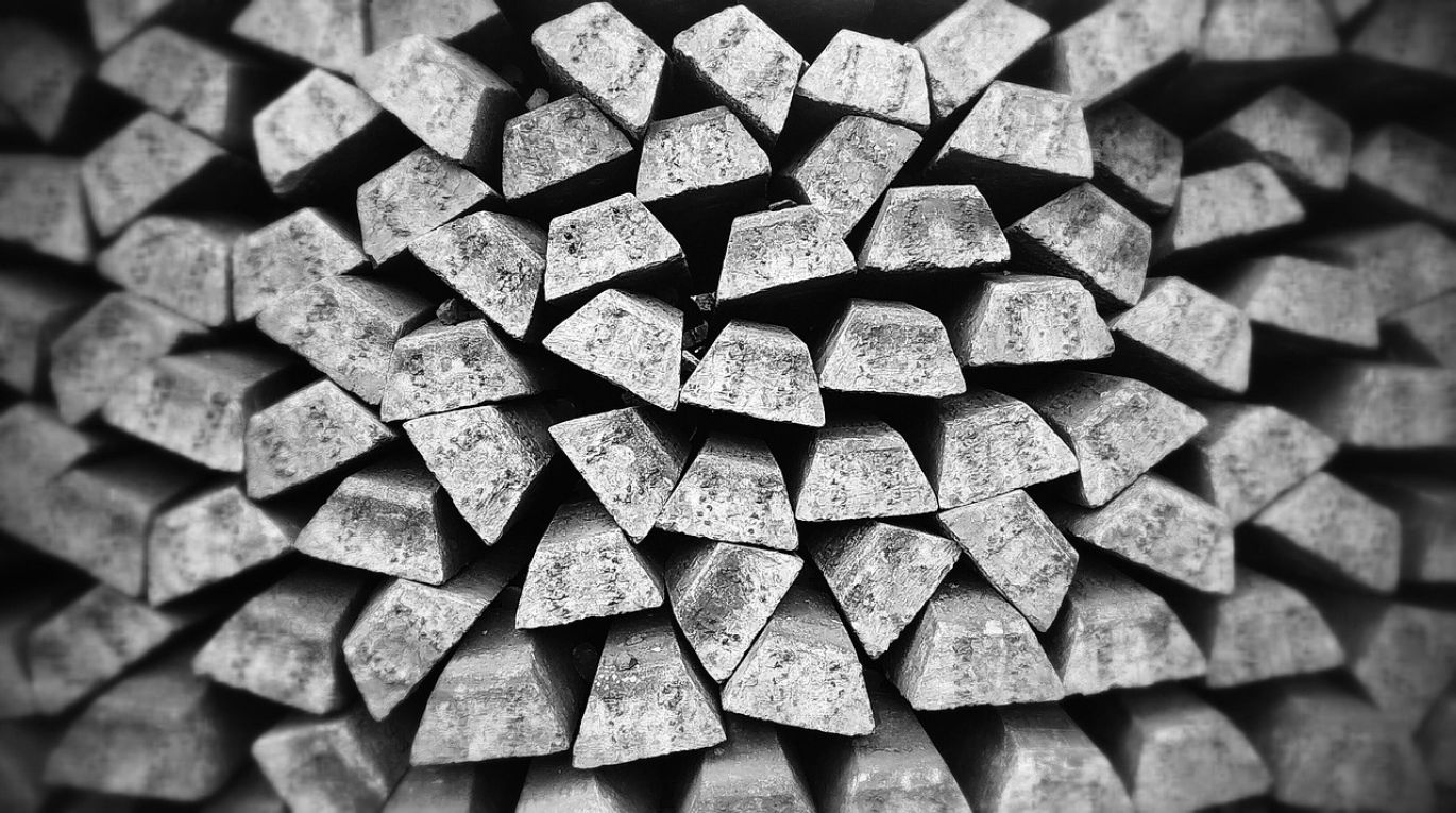 Close-up of Apmex Silver Bullion bars stacked neatly, representing investment.