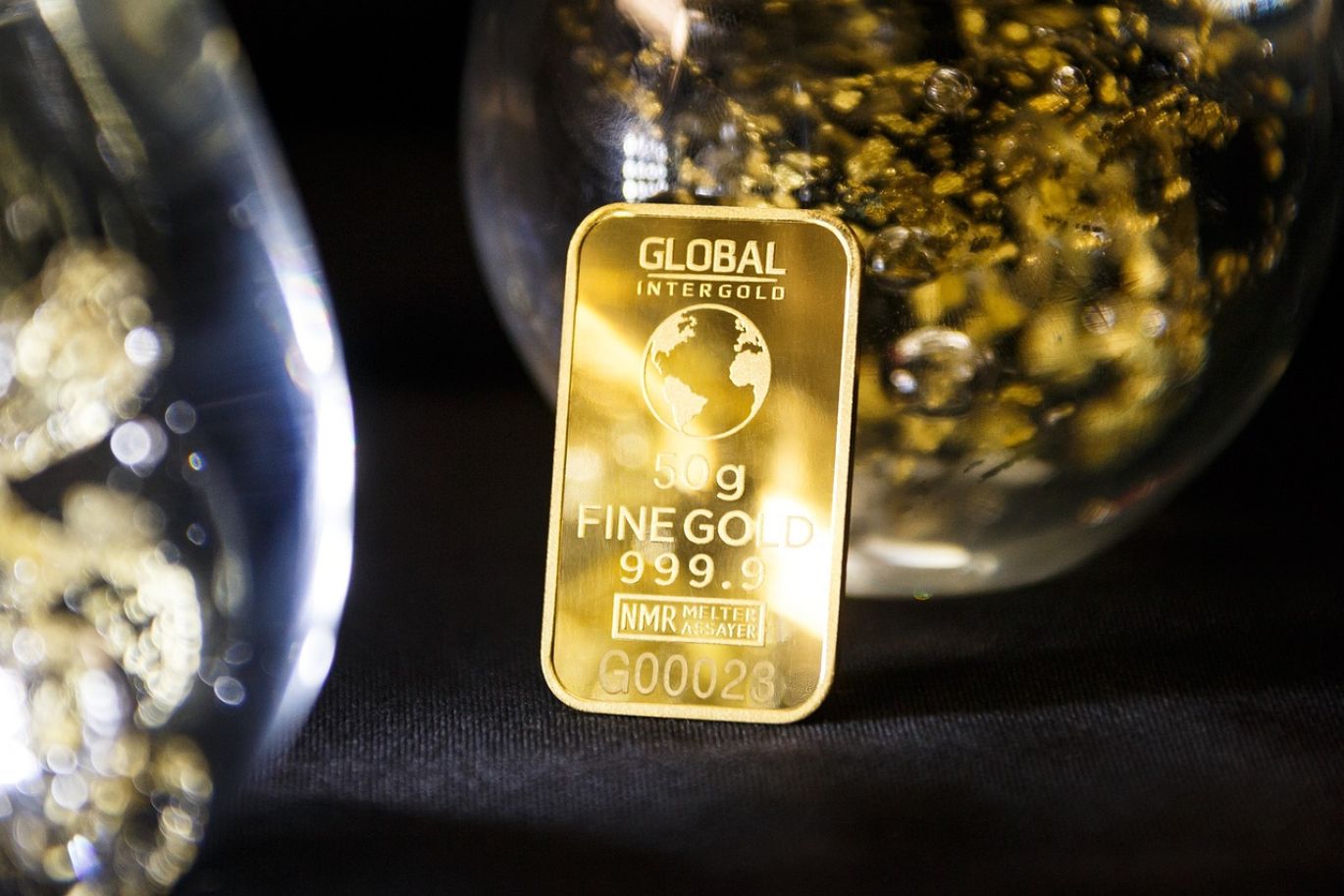 Gold bars representing the Best Companies To Buy Gold, with Maiyam Group logo.