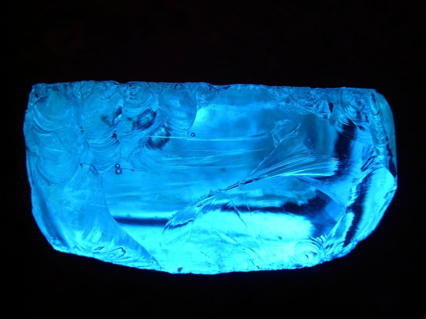 Close-up of various raw crystals and minerals displayed in bulk for sale.