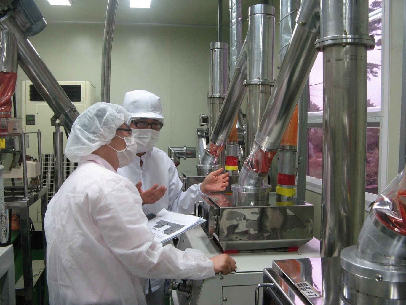 Workers overseeing the Dolomite Powder Manufacturing Process in an industrial facility.