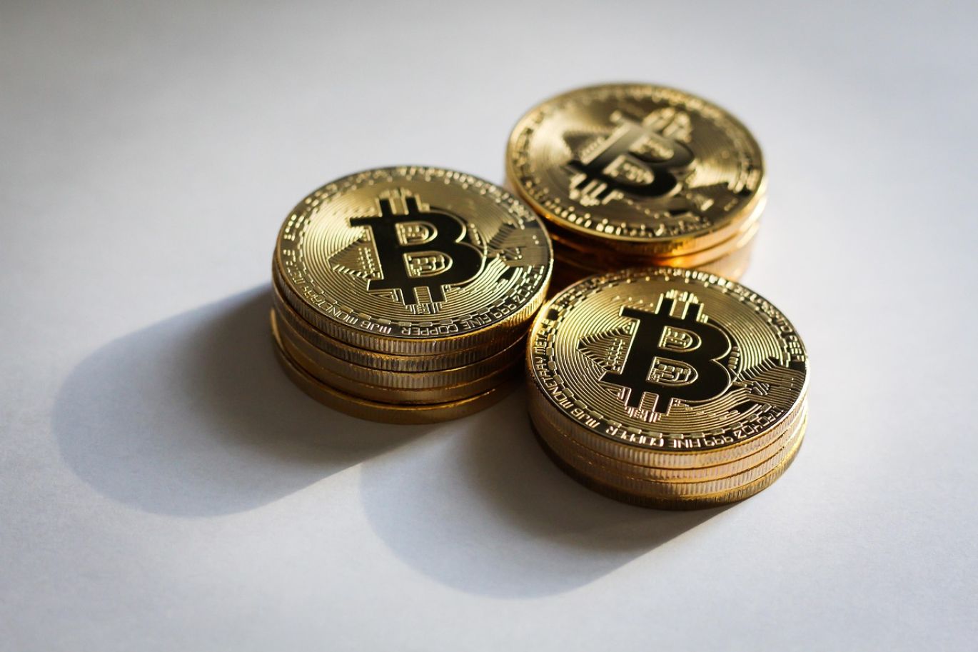 Close-up of gleaming gold coins for sale, showcasing their intricate details and precious metal value from Maiyam Group.