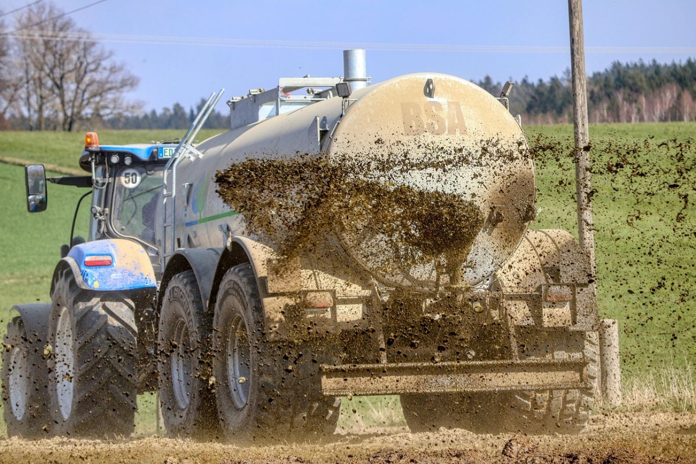 Magnesium Hydroxide Fertilizer being applied to farmland in Kenya for crop health.