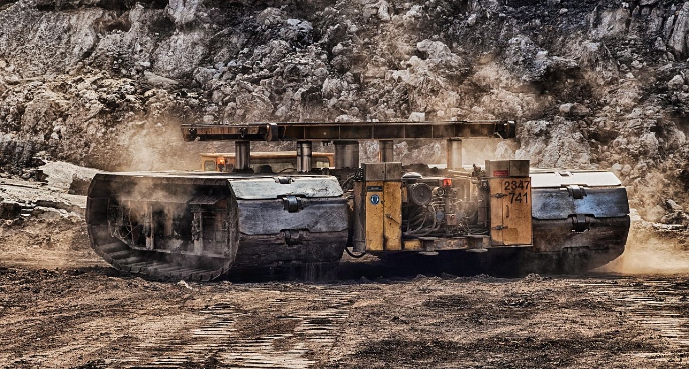 Miner holding raw materials in a mine in Kenya, representing Maiyam Group's mining raw materials services.