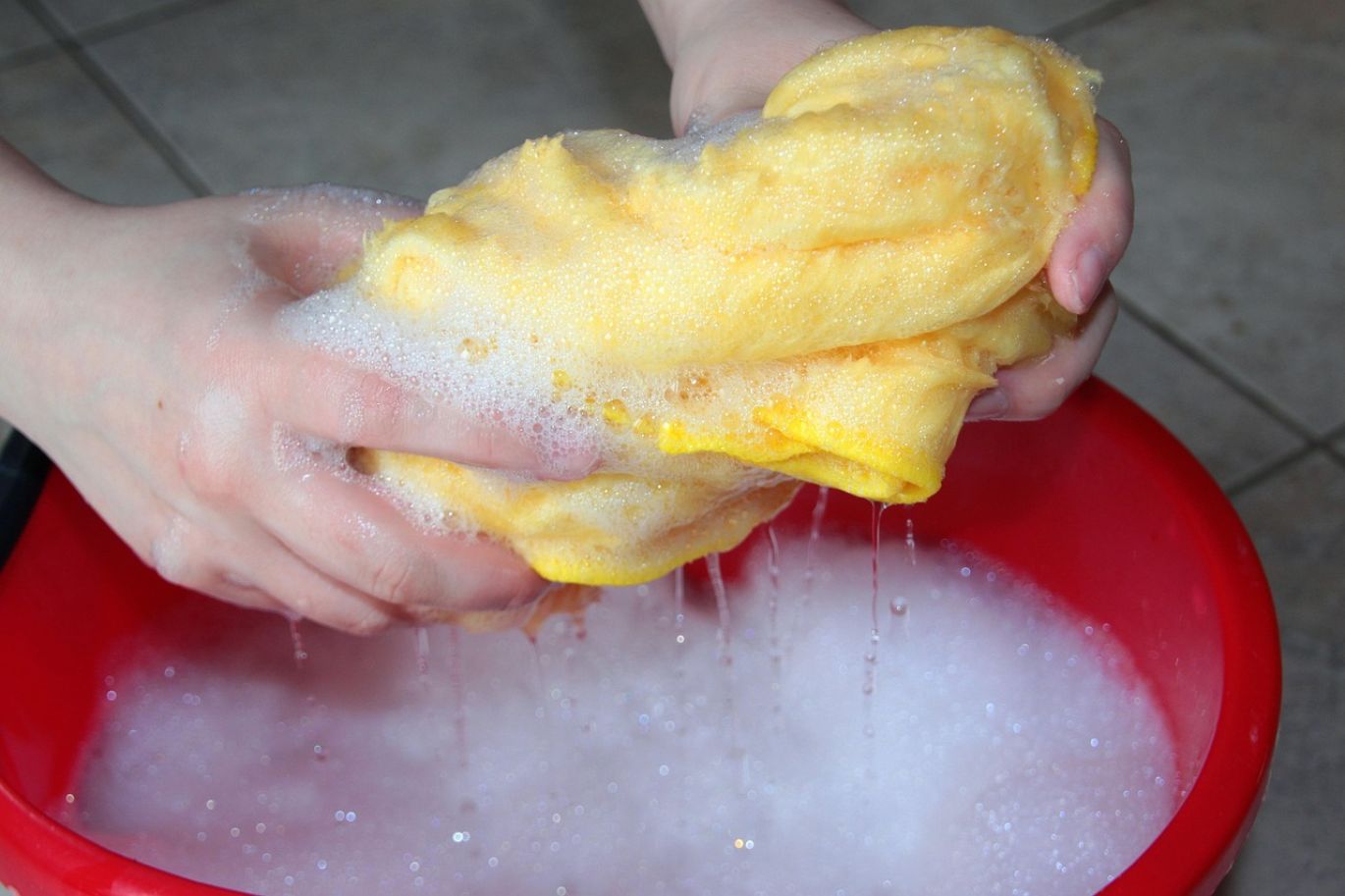 Close-up of rocks being cleaned with muriatic acid solution, showing stain removal.