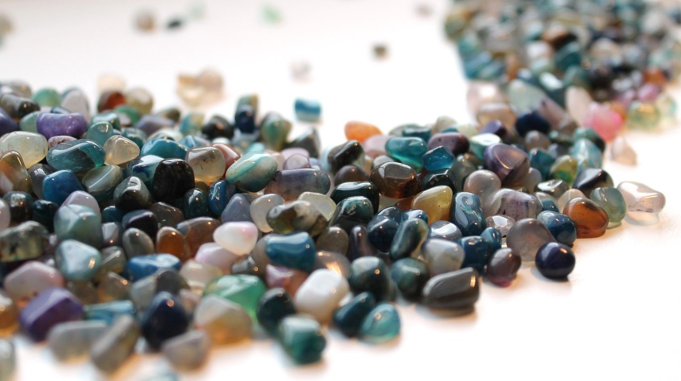 A selection of polished natural gemstones, including vibrant sapphires and emeralds, offered for Natural Gemstones Wholesale.