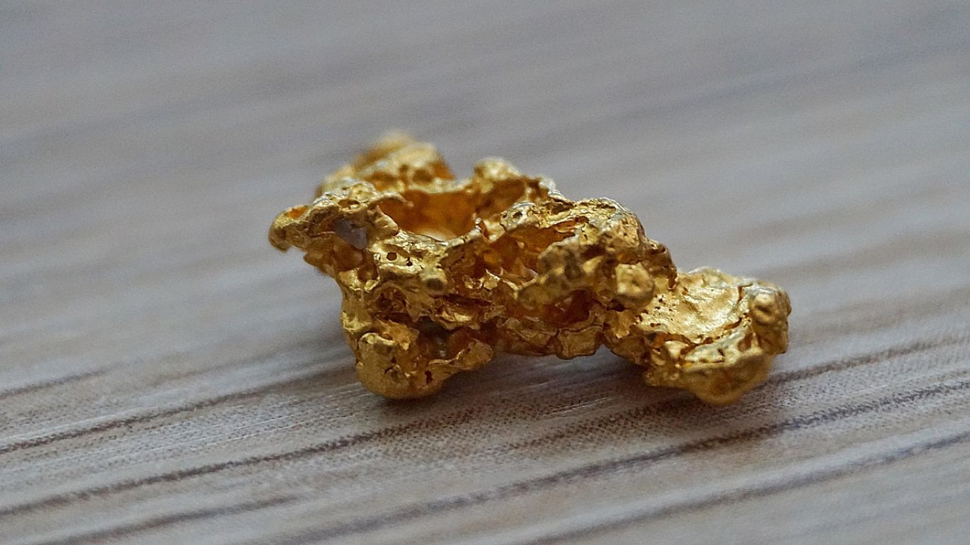 A close-up of shiny gold bars, representing a Noble Gold Ira investment.
