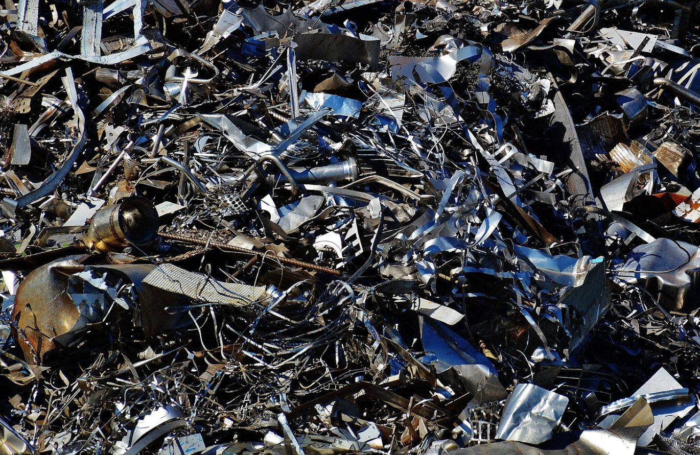 A close-up of gold jewelry being weighed on a digital scale, representing the process to sell scrap gold near me.