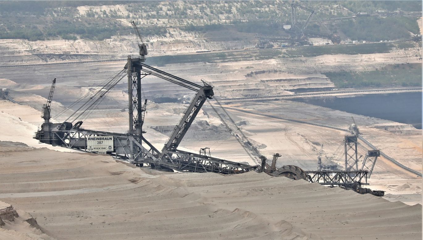 Silica sand mining operation in Kenya with workers and heavy machinery