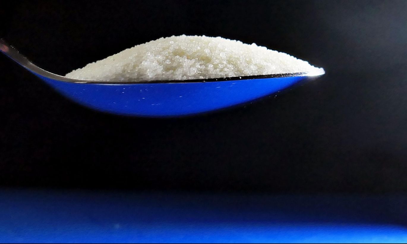 Close-up of white Soda Crystals Sodium Carbonate powder in a container for industrial applications