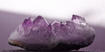 A polished sunstone gemstone with vibrant orange and gold inclusions, showcasing the beauty of Sunstone Mining in Kenya.