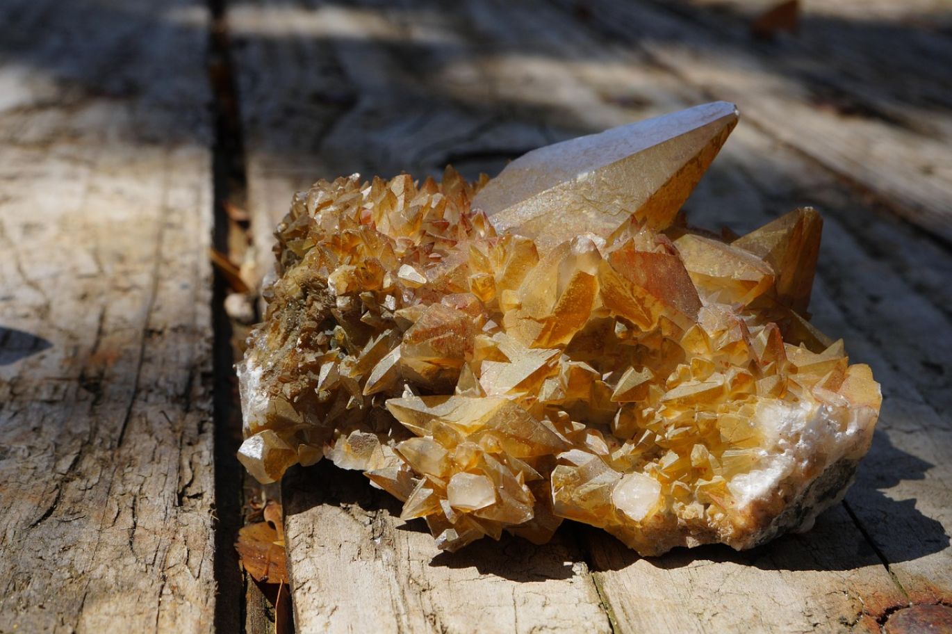 Close-up of various unprocessed Wholesale Mining Rough minerals on a surface, representing raw geological materials.